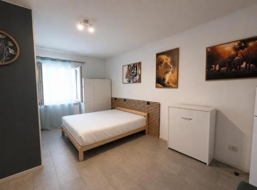 a bedroom with a white bed and a window at Mercury Room in Limbiate