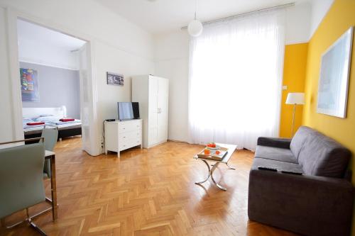 a living room with a couch and a table at City Centre Cosy Apartments in Budapest