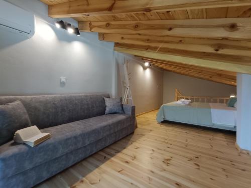 a living room with a couch and a bed at River Houses Molyvos in Mythimna