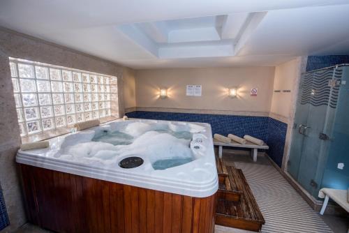 a large jacuzzi tub in a bathroom at Reef Oasis Beach Aqua Park Resort in Sharm El Sheikh