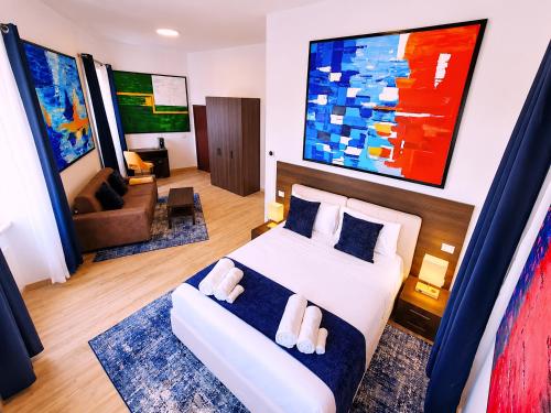 a bedroom with a bed and a living room at Baglioni Art Suite in Perugia