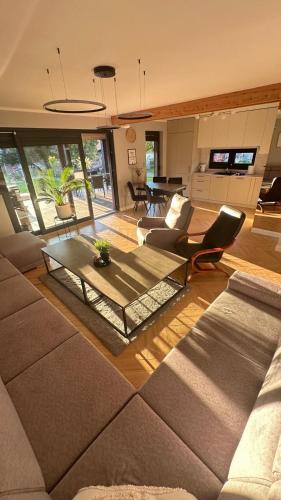 a living room with a couch and a table at Stodoła przy deptaku in Ujsoły