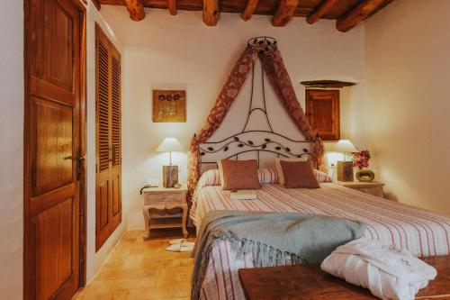 a bedroom with a large bed in a room at Can Pardal in Sant Miquel de Balansat