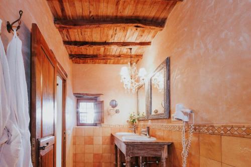 a bathroom with a sink and a mirror at Can Pardal in Sant Miquel de Balansat