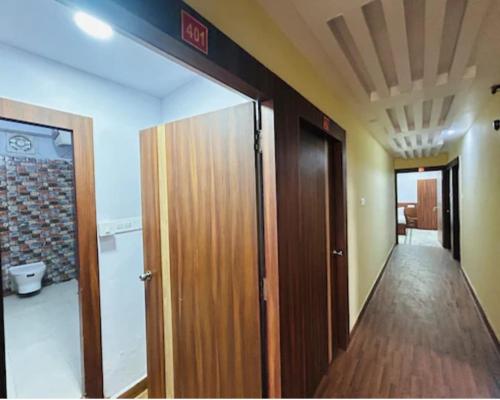 a hallway with an open door in a room at hotel darbar international in Gaya