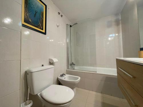 a white bathroom with a toilet and a bath tub at TXIMELETA Haro in Haro