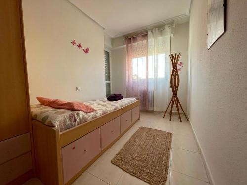 a bedroom with a bed with a dresser and a window at TXIMELETA Haro in Haro