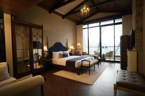 a bedroom with a bed and a living room at Van Rāsa in Kasauli