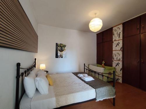 a bedroom with a bed with pillows and a lamp at Casa Os Maias - Jardim, terraço e espaço para 10 pessoas in Mirandela