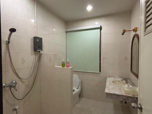 a bathroom with a shower and a toilet and a sink at Kat's GuestHouse in Hua Hin
