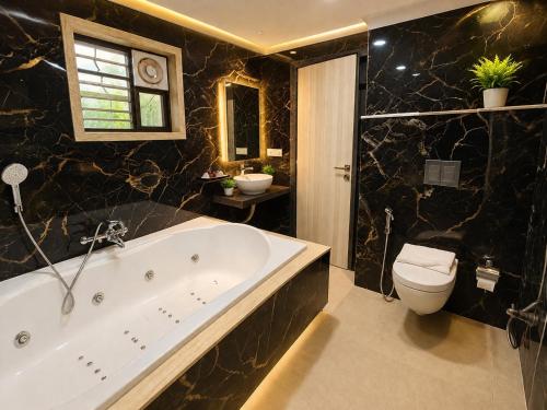 a bathroom with a tub and a toilet and a sink at BHAGYA SHREE Hotel in Nokha