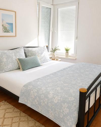 a bedroom with a large bed with white sheets at Villa Jurisic in Tučepi