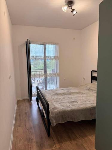 a bedroom with a bed and a large window at Bazaleti Lake Escape in Bazalet'i