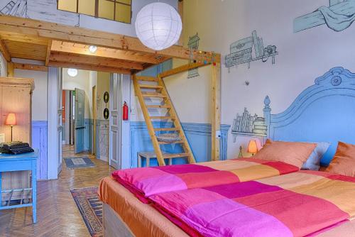 a bedroom with a bunk bed with a ladder at Lavender Circus Hostel, Doubles & Ensuites in Budapest