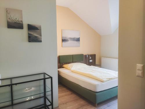 a bedroom with a bed and a glass table at Rosenhotel - Serviced Apartments in Zwentendorf
