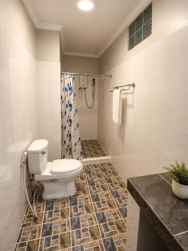 a bathroom with a toilet and a shower at Abode Hotel Siem Reap in Phum Pobos