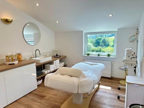 a hospital room with a bed and a sink at Ringhotel Siegfriedbrunnen in Grasellenbach
