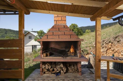 a wood fired pizza oven under a pergola at Villa Velebita House for 9 near Plitvice Lakes in Rudopolje