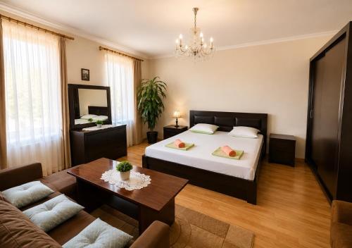 a bedroom with a bed and a living room at Mountain Home Inn-Guesthouse in Lagodekhi
