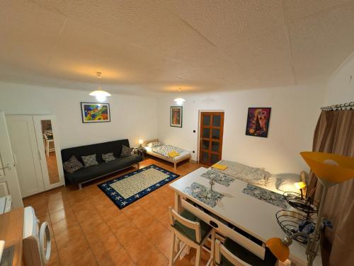 a living room with a couch and a table at B59 mini in Budakalász