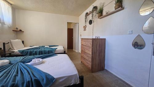 a room with two beds and a dresser in it at Spyros comfy and cool place in Karianí