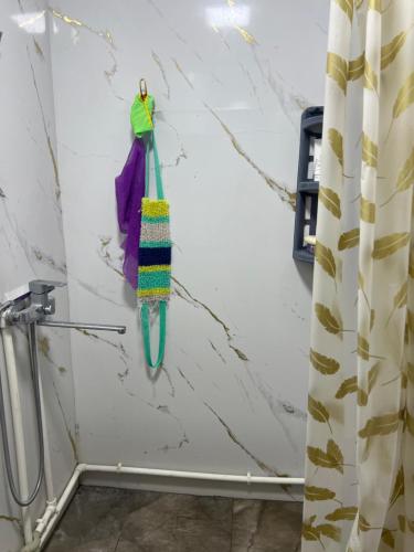 a towel hanging on a wall next to a shower curtain at ЭКО -Балык 