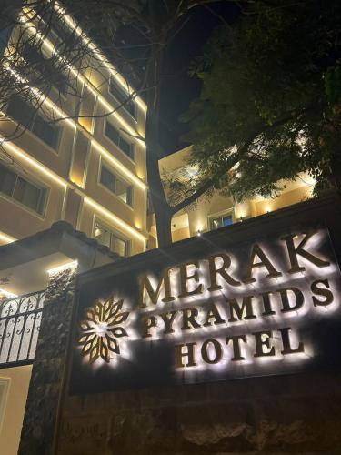a sign in front of a hotel at night at Pyramids view M in Cairo