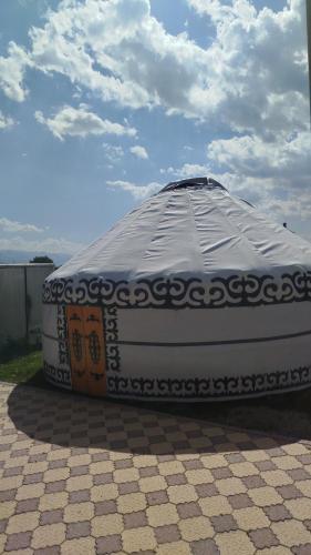 a large mattress sitting on top of a patio at Akmuz House in Ak-Muz
