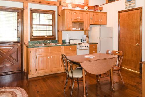 a kitchen with wooden cabinets and a table with chairs at The Lake House A Hidden Gem Sleeps 4 in Columbia
