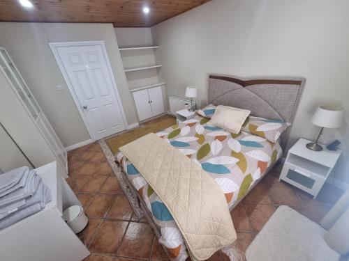 a bedroom with a bed with a comforter on it at Oyster Lodge shared accomadation in Galway