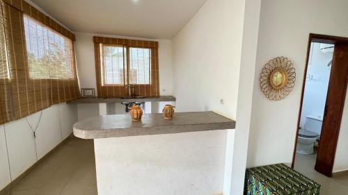 a bathroom with a counter with a sink and a mirror at Villa La Pommone in Somone
