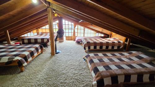 a room with four beds in a attic at El Peregrino in Cota