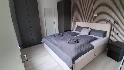 a bedroom with a large bed with blue pillows at Haus Küstenglück in Neuharlingersiel