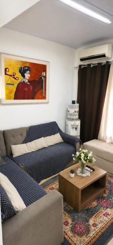 a living room with a couch and a table at Pousada da Juh in Campo Grande