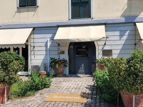 a front door of a building with plants and flowers at Sarzana Park Hotel in Sarzana