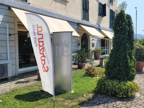 a sign in the grass in front of a building at Sarzana Park Hotel in Sarzana