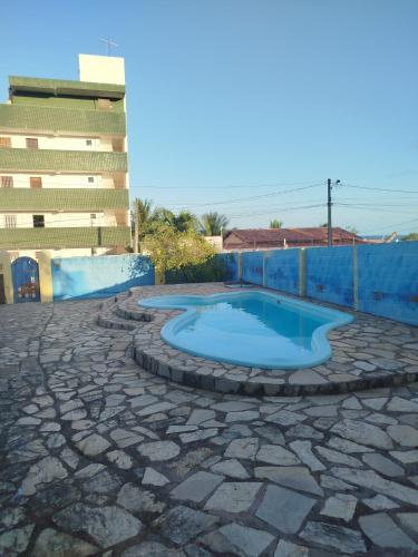 a small swimming pool on a stone patio at Recanto Das Marés in Jacumã