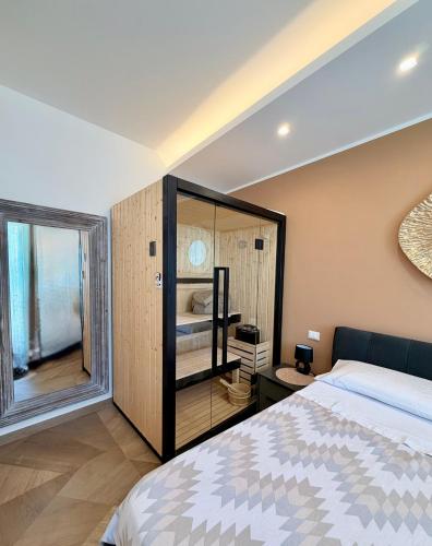 a bedroom with a bed and a large window at Las Palomas in Santa Flavia