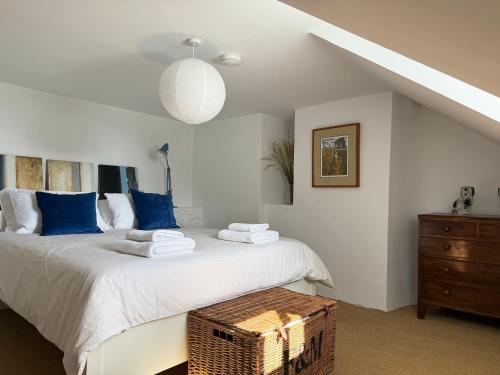 a bedroom with a large bed with blue pillows at The Old Manse, Horton in Horton