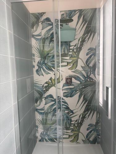 a bathroom with a wall mural of plants at Residence Prato in Trapani