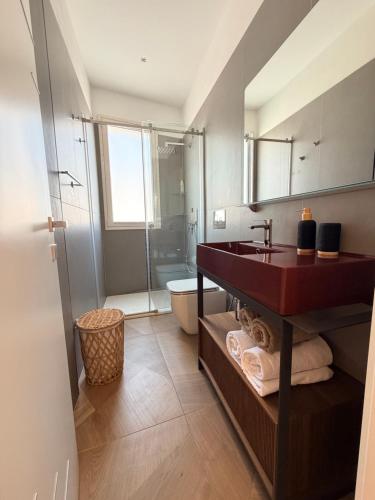 a bathroom with a sink and a toilet and a shower at Las Palomas in Santa Flavia