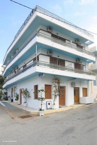 a white building with a blue at Hotel Karpathos in Karpathos