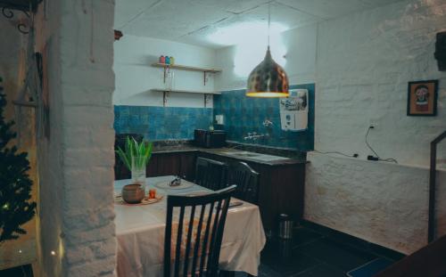 a kitchen with a table and a sink and a table and chairs at Mellowmine Premier in Kokliyal Gaon