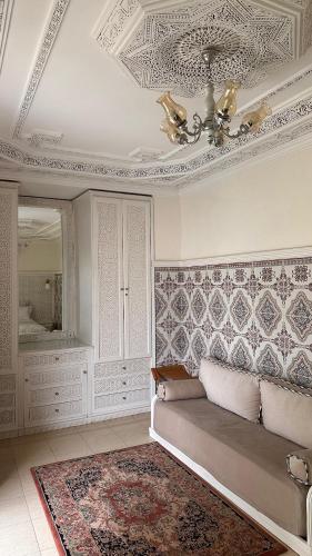 a living room with a couch and a ceiling at Riad Darabi l Private Medina Home in Marrakesh