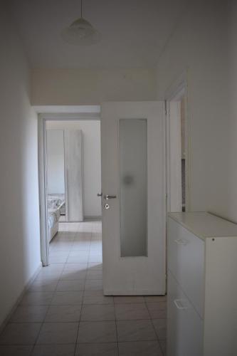 an empty white room with a door and a window at Appartamento Rubiana in Rubiana