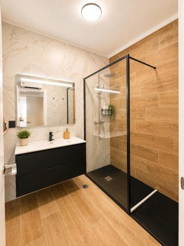 a bathroom with a sink and a shower at Ponte Velha in Peniche