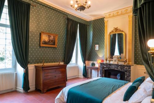 a bedroom with a bed and a fireplace at Chateau de Mons Gard prés d Uzes in Mons