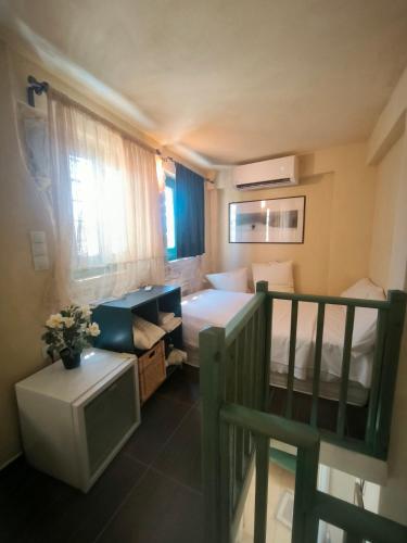 a small room with a bed and a desk in a room at Kritikies 1 Ariadne in Pitsidia