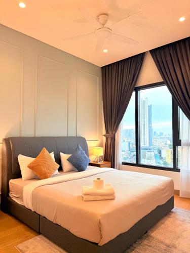 a bedroom with a large bed with a large window at Lucentia Residence BBCC Modern City View Stay in Kuala Lumpur