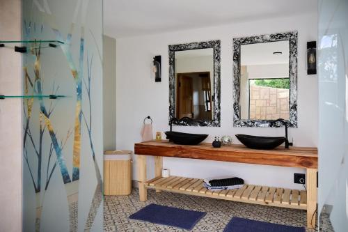 a bathroom with two sinks and a mirror at Wish You Were Here! in Wilderness